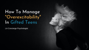 overexcitable teen tossing hair on black background