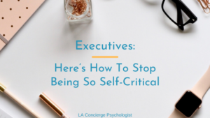 pink office supplies on white desk how to stop being so self-critical