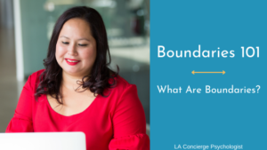 woman in red blouse sitting in front of laptop smiling