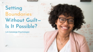 black woman with glasses and short curly hair in white blouse and pink blazer smiling